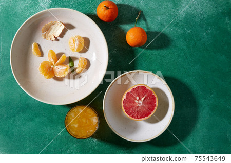 mandarins, grapefruit and glass of juice 75543649