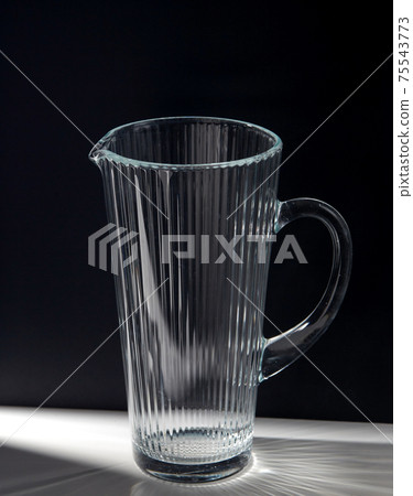 empty faceted glass jug on table 75543773