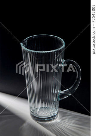 empty faceted glass jug on table 75543805