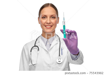 smiling female doctor with medicine in syringe smiling female doctor with medicine in syringe 75543982