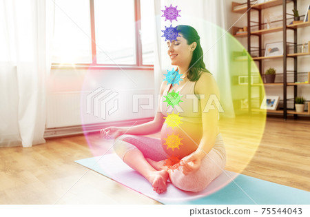 happy pregnant woman meditating with seven chakras happy pregnant woman meditating with seven chakras 75544043