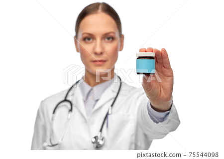 female doctor holding jar of medicine female doctor holding jar of medicine 75544098