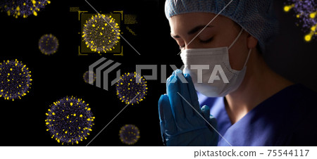 female doctor or nurse in face mask praying female doctor or nurse in face mask praying 75544117