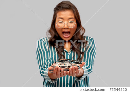 surprised asian woman with glasses 75544320