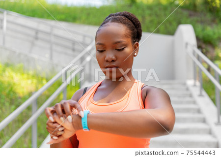 african woman with fitness tracker outdoors 75544443