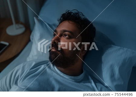 speelpess indian man lying in bed at night speelpess indian man lying in bed at night 75544496