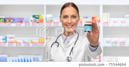 smiling female doctor with medicine at pharmacy smiling female doctor with medicine at pharmacy 75544604