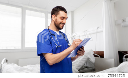 male doctor writing medical report on clipboard 75544725