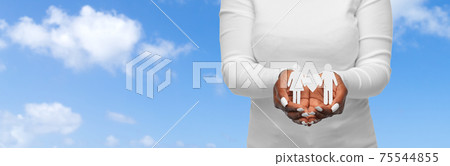 close up of african american woman holding couple 75544855