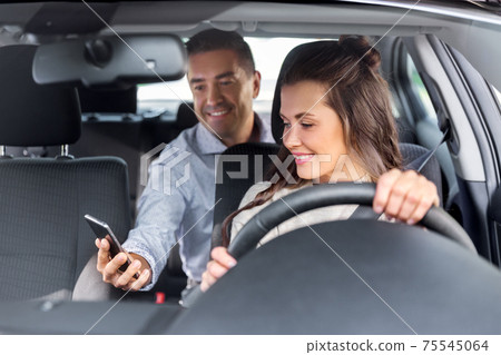 female driver driving car with male passenger 75545064