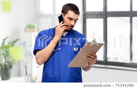 doctor or male nurse calling on smartphone doctor or male nurse calling on smartphone 75545284