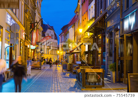 Night view of Torun streets and building illuminated at dusk 75545739