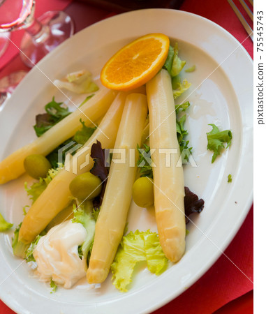 Baked white asparagus with greens Baked white asparagus with greens 75545743