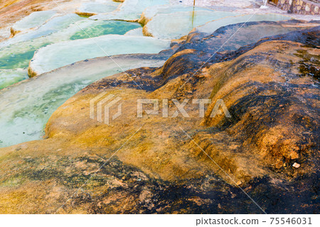 Brownish travertine formations at thermal springs in Karahyit, Turkey Brownish travertine formations at thermal springs in Karahyit, Turkey 75546031