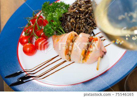 Tasty stuffed sea squid with peppers, eggs and wild rice Tasty stuffed sea squid with peppers, eggs and wild rice 75546165