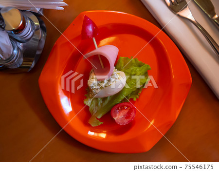 Devilled egg in shape of ship with sausage slice and fresh vegetables Devilled egg in shape of ship with sausage slice and fresh vegetables 75546175