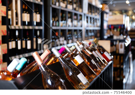 Rack with various wine bottles in modern wine store waiting for customers 75546400