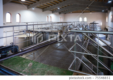 Stainless steel tanks in interior of modern winery Stainless steel tanks in interior of modern winery 75546651