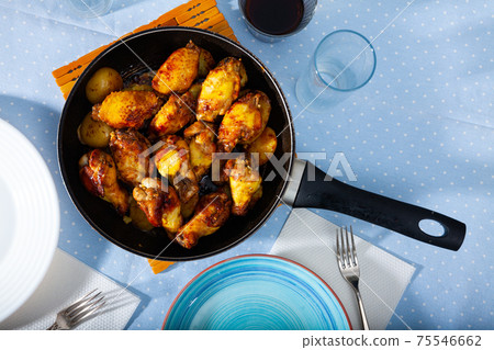 grilled chicken wings in skillet for lunch 75546662