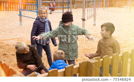 Happy children playing blind man bluff 75546924