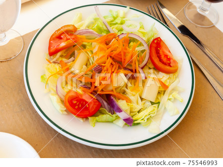 Salad from fresh lettuce, tomato, onion, grated carrot and pickled asparagus Salad from fresh lettuce, tomato, onion, grated carrot and pickled asparagus 75546993