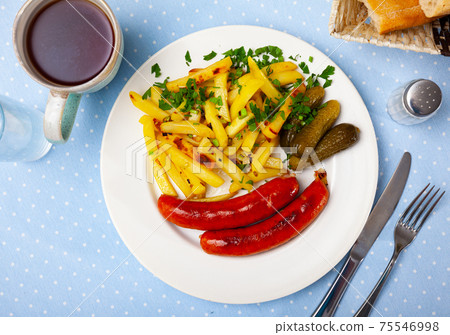 Sausages with potatoes and pickled cucumbers Sausages with potatoes and pickled cucumbers 75546998