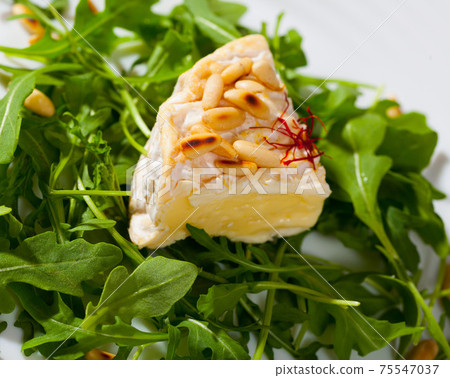 Camembert with roasted pine nuts on arugula Camembert with roasted pine nuts on arugula 75547037