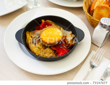 Traditional Spanish vegetable escalibada with melted goat cheese 75547077