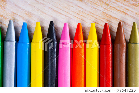 Multicolored pastel pencils on wooden background 75547229