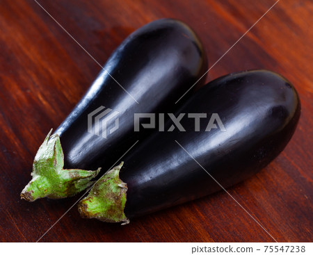 Aubergine on wooden table Aubergine on wooden table 75547238
