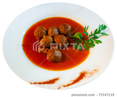Close up of traditional spanish meatballs on white plate on red tablecloth Close up of traditional spanish meatballs on white plate on red tablecloth 75547239