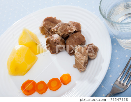 Close up of tasty steamed turkey with boiled potatoes and carrots Close up of tasty steamed turkey with boiled potatoes and carrots 75547558