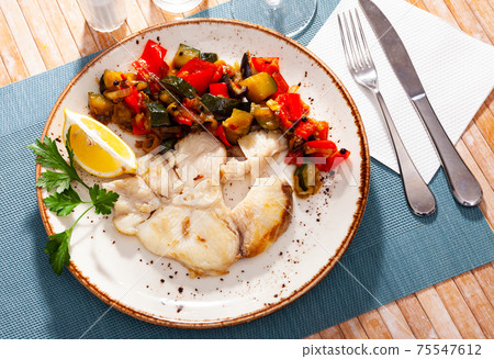 Fried steak of blue shark with baked vegetables and lemon Fried steak of blue shark with baked vegetables and lemon 75547612