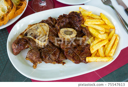Delicious grilled beef with french fries at the plate Delicious grilled beef with french fries at the plate 75547613