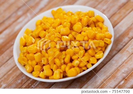 Close up of preserved maize in plate on table 75547700
