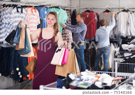 Woman displaying shopping bags Woman displaying shopping bags 75548168