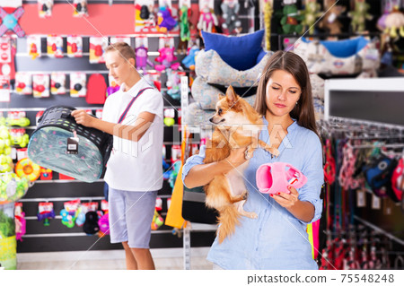 woman visiting pet shop in search of supplies woman visiting pet shop in search of supplies 75548248