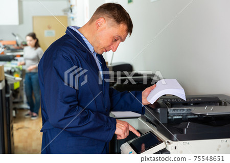 Service engineer of the printing house during work Service engineer of the printing house during work 75548651