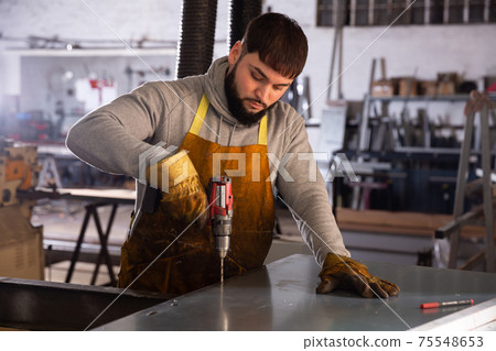 Factory worker with screwdriver Factory worker with screwdriver 75548653