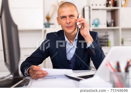 Man office worker deciding and talking on phone 75548696