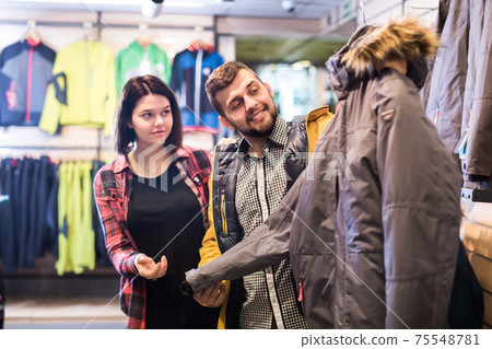 Guy and woman choosing a new windcheater 75548781