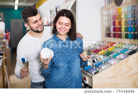 Family are deciding on materials for decorating house Family are deciding on materials for decorating house 75548846
