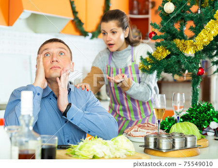 Unhappy woman quarreling with husband during cooking Unhappy woman quarreling with husband during cooking 75549010