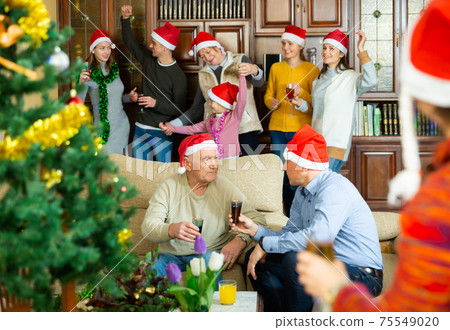 Family spending time together on Christmas night Family spending time together on Christmas night 75549020