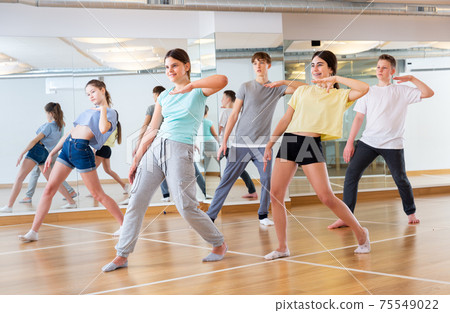 Teenage dancers practicing new dance in studio Teenage dancers practicing new dance in studio 75549022