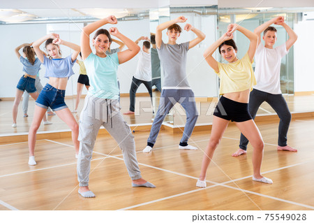 Teenage dancers practicing new dance in studio Teenage dancers practicing new dance in studio 75549028