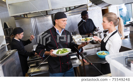 Staff of restaurant with chef working Staff of restaurant with chef working 75549248