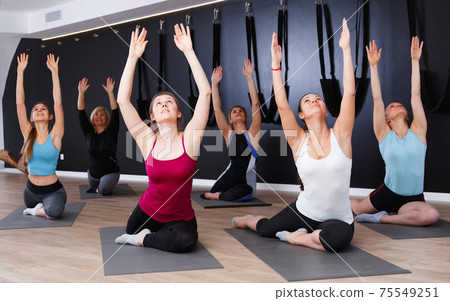 Females practicing yoga in studio Females practicing yoga in studio 75549251