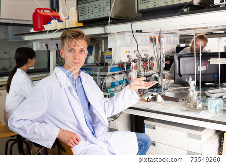 Male scientist sitting at biochemical lab Male scientist sitting at biochemical lab 75549260