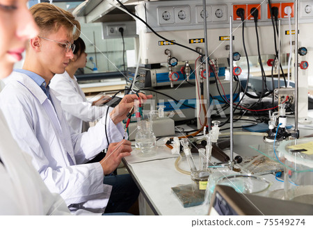 Student performing experiments in laboratory Student performing experiments in laboratory 75549274